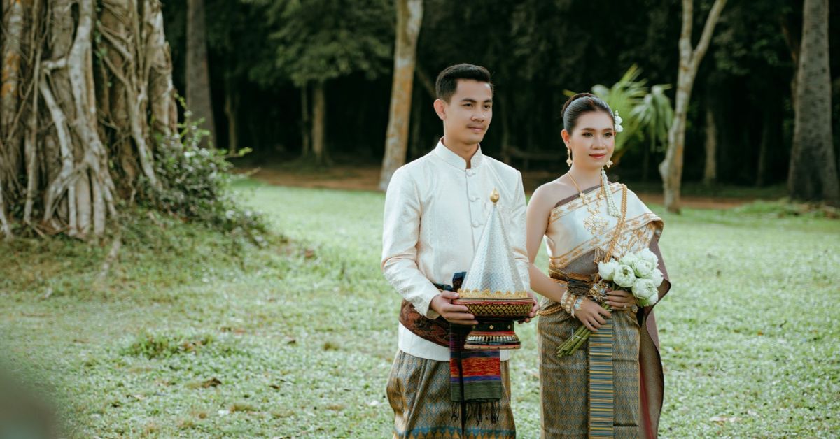 Cambodian bride and groom in traditional silk sampot and golden crown for a Khmer wedding